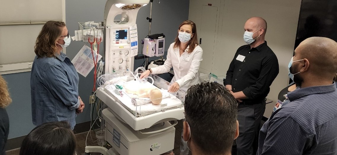 BOPN instructor teaching a small group at an infant warmer